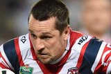 The Roosters' Mitchell Pearce breaks a tackle from Bulldogs' Josh Jackson in NRL round 10, 2015.