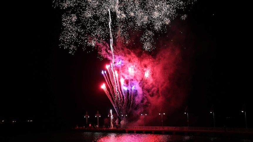 Fire works: Streams of red light streak up into the black sky beneath a large burst of gold specks.