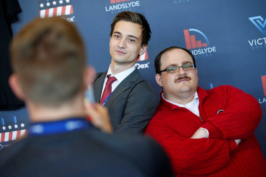 A young audience member poses with Ken Bone who became a social media sensation