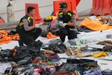 Officials inspect personal belongings retrieved from the waters where Lion Air flight JT 610 is believed to have crashed.