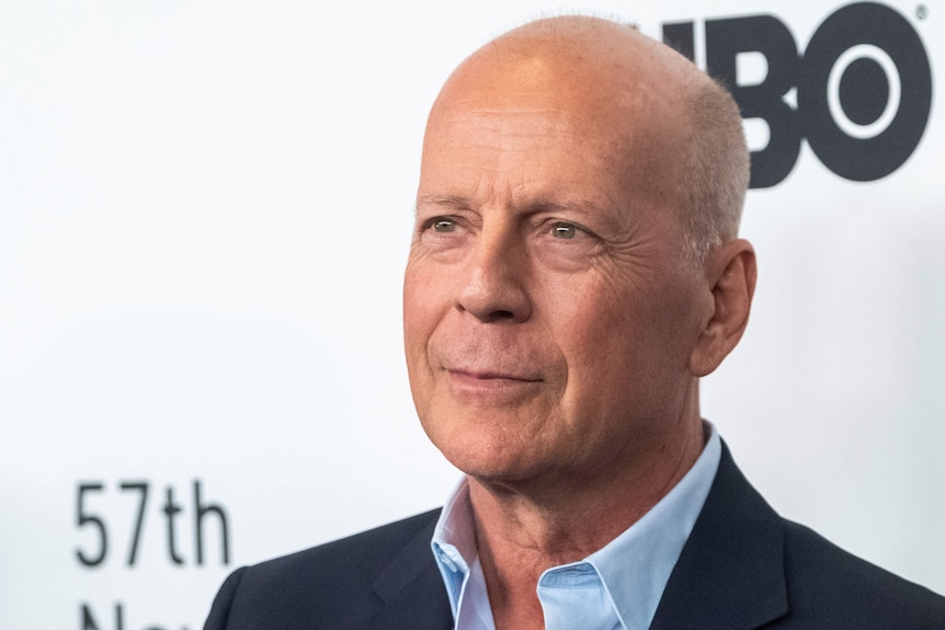 Bruce Willis attends a movie premiere with a shaved head.