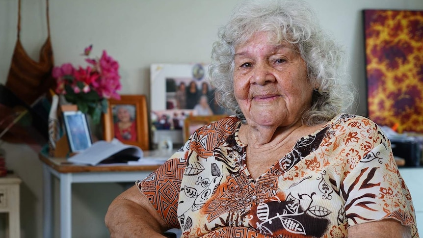 Kathy Mills, an indigenous elder, sits in her living room.
