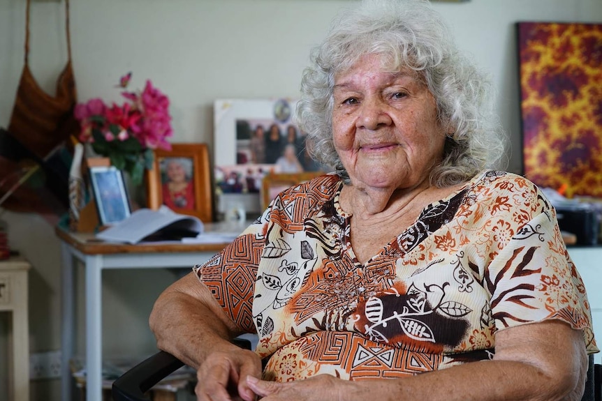 Kathy Mills, an indigenous elder, sits in her living room.