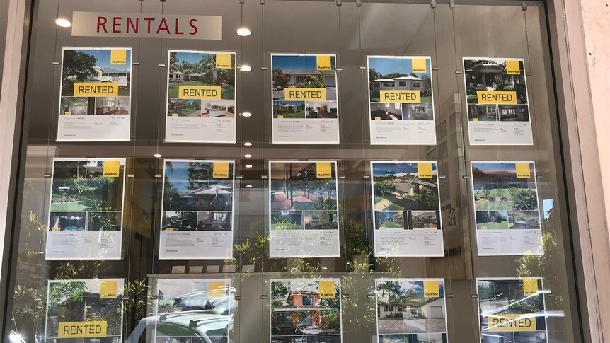 Posters of rental properties in a real estate window