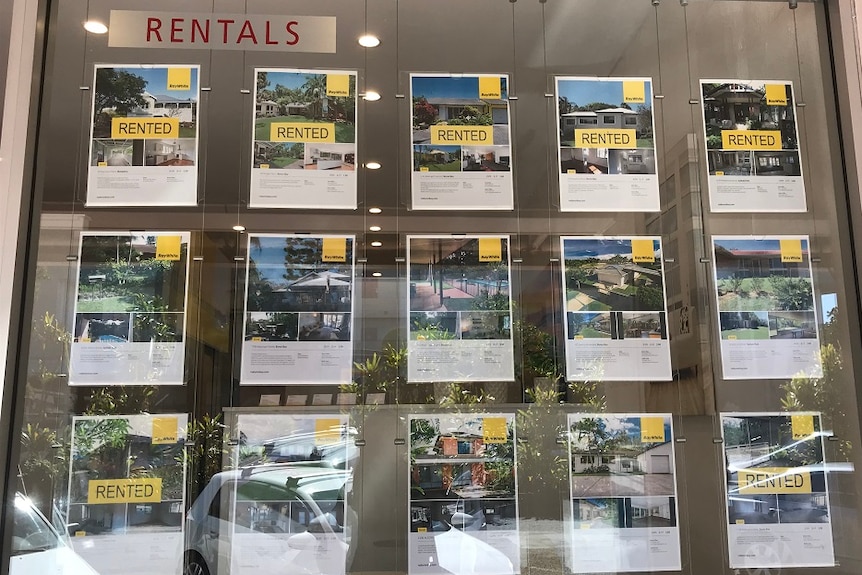 Posters of rental properties in a real estate window