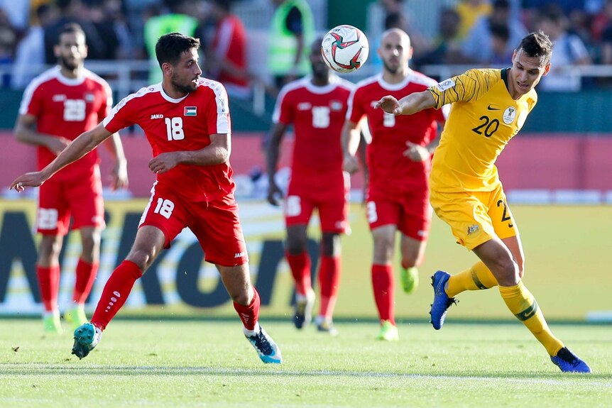 Trent Sainsbury vies for possession of the ball for Australia against Palestine