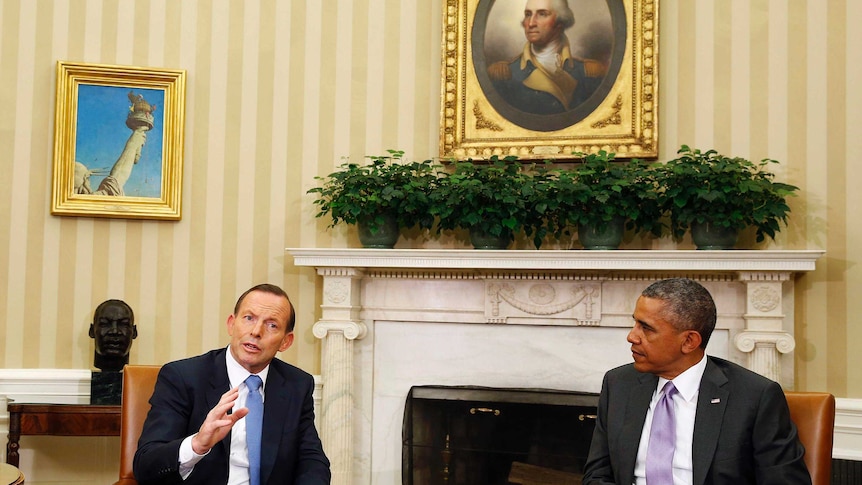 US President Barack Obama listens as Prime Minister Tony Abbott speaks during their bilateral meeting.
