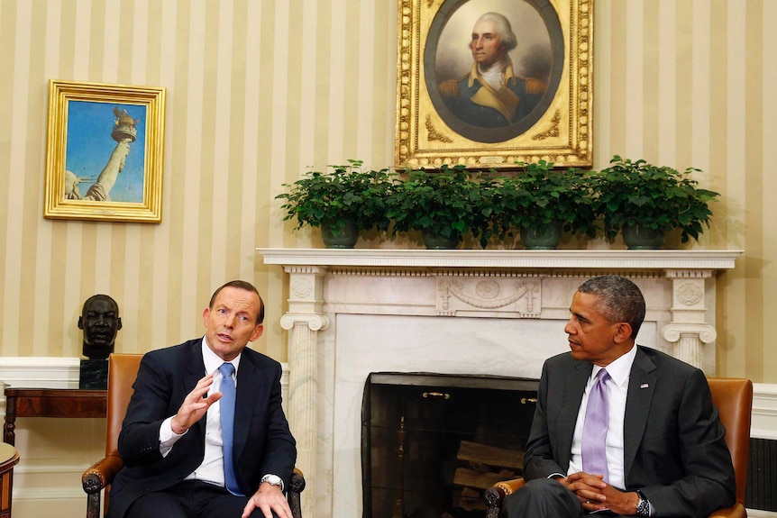 US President Barack Obama listens as Prime Minister Tony Abbott speaks during their bilateral meeting.