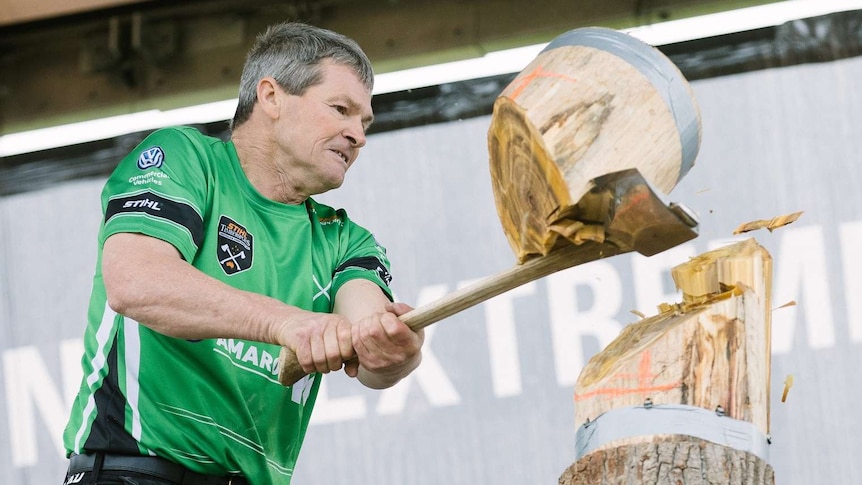A lumberjack finishes a standing block event