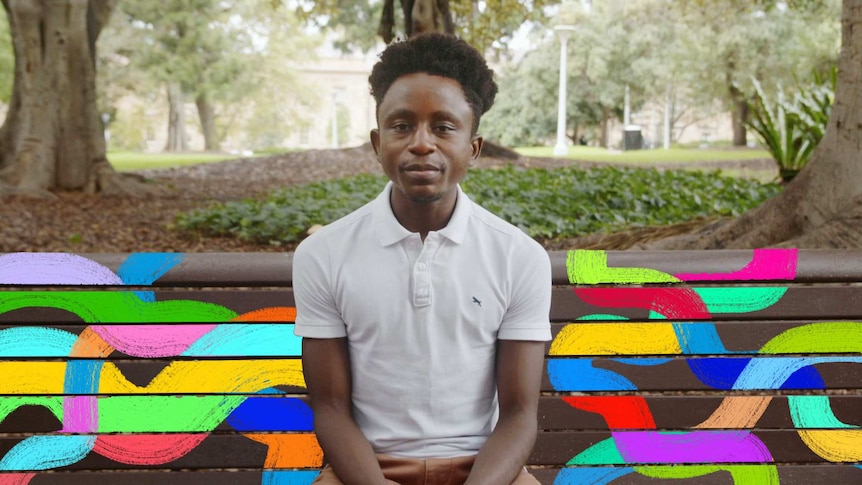 Lambert Majambele on a seat in a park for Sonder video series