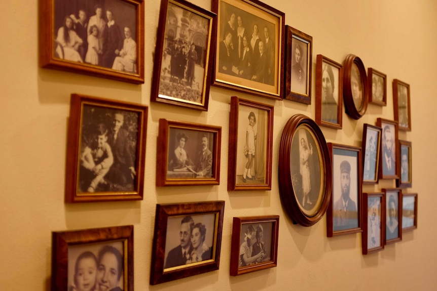 Old, black and white photos of Ashkenazi Jewish family members decorate the hallway.