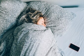 Woman in bed with phone