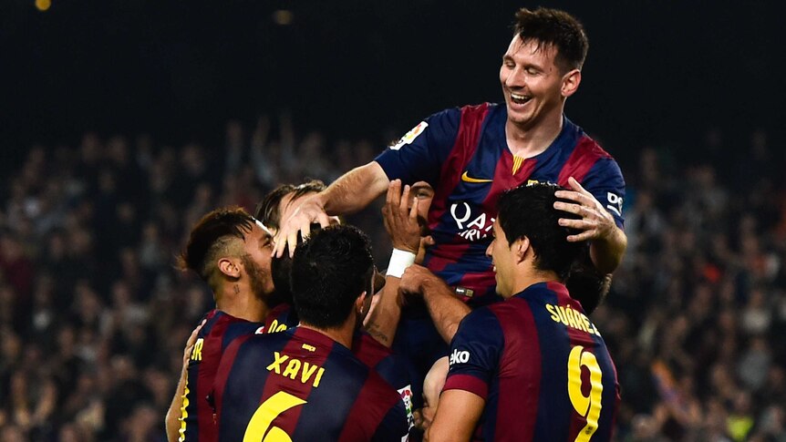 Barcelona's Lionel messi celebrates with team-mates after breaking La Liga goalscoring record.