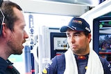 Segio Perez with engineers in the Red Bull garage at the Brazilian Formula 1 Grand Prix.