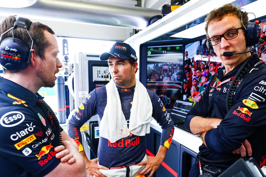 Segio Perez with engineers in the Red Bull garage at the Brazilian Formula 1 Grand Prix.