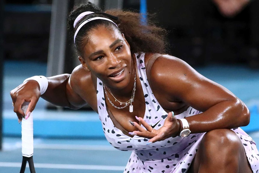 Serena Williams shrugs while down on one knee during her Australian Open match against Tamara Zidansek.