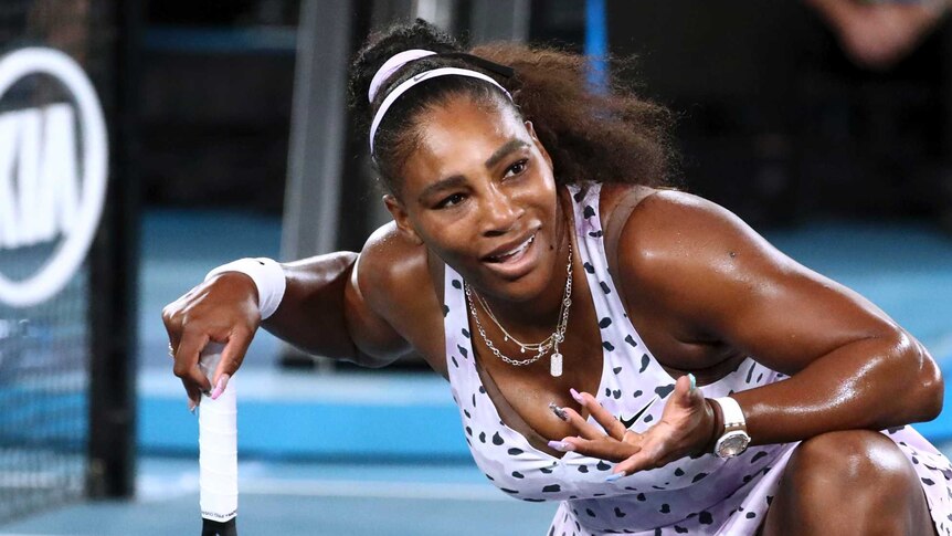 Serena Williams shrugs while down on one knee during her Australian Open match against Tamara Zidansek.