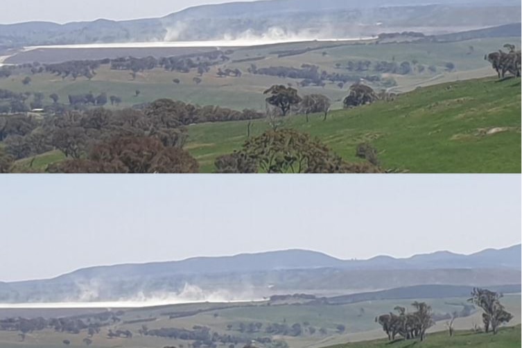 Dust rises from a mine tailings dam.