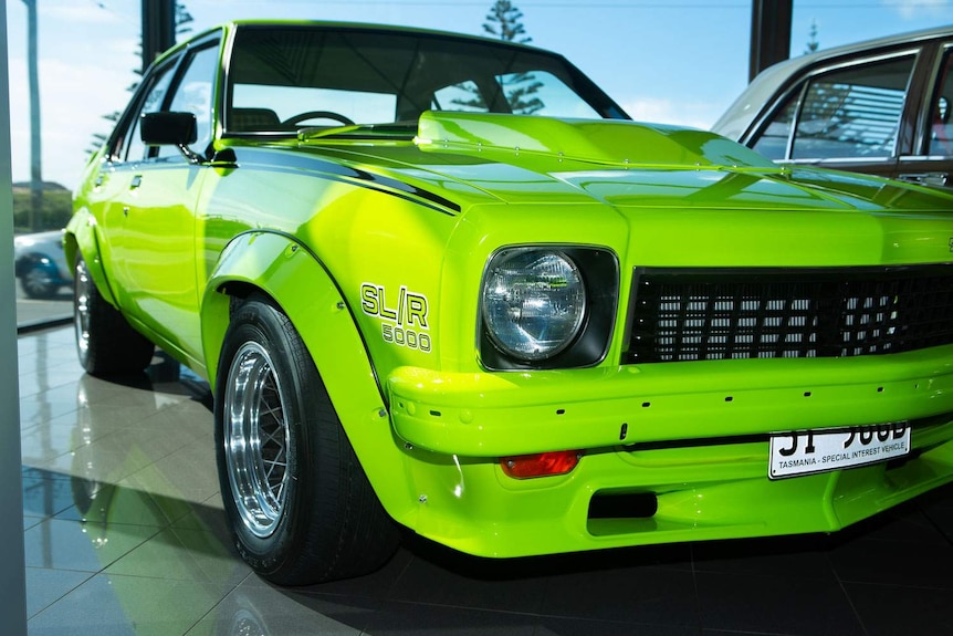 A bright green historic SLR Torana viewed from the front