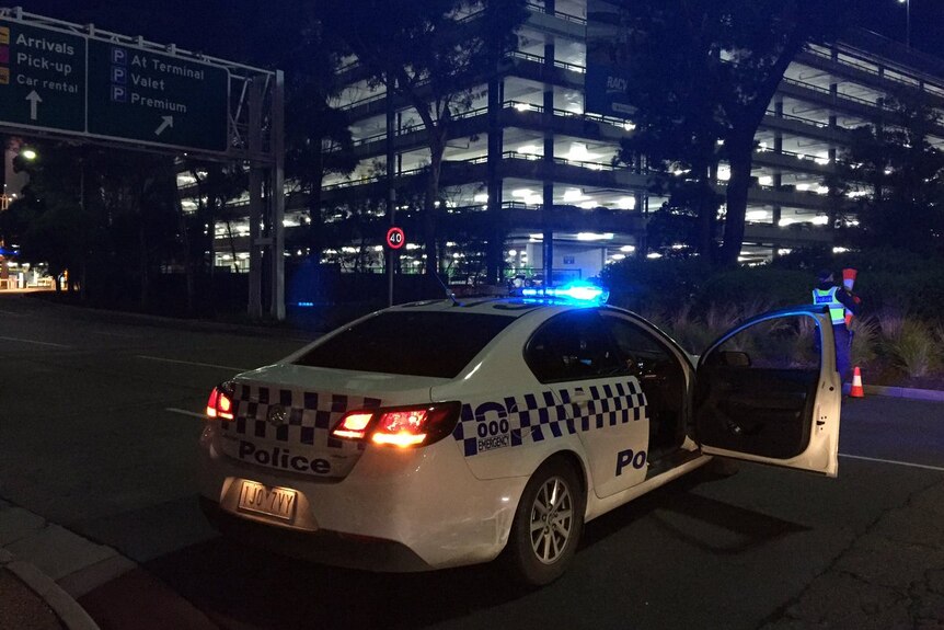 A police car blocks a road into Melbourne airport.