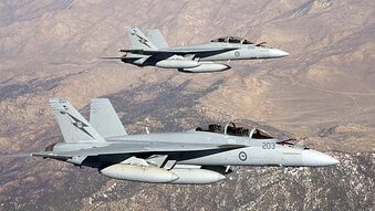 Two Australian Super Hornets perform a work up flight over the Sierra Nevada Mountain Ranges in California. (Department of De...