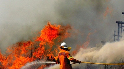 A Rural bush fire fighter tries to extinguish a fire that was headed towards homes Belrose