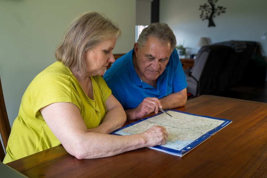 Debbie and Erich Turner look at a map