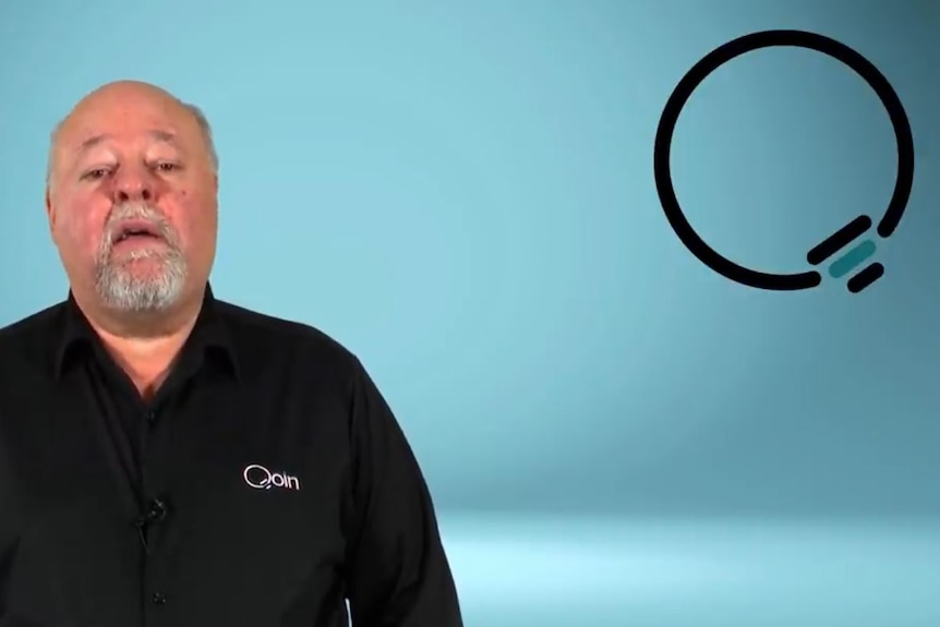 An older man with a neat grey beard, wearing a dark shirt, speaks in a YouTube video.