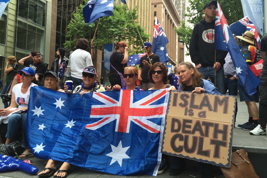 A group of women hold Australian flags and a sign calling Islam a 'death cult.'