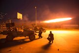 Shiite fighters fire a rocket during clashes with Islamic State