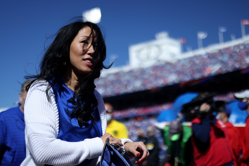 An NFL team owner is pictured in a stadium walking off to the stands prior to an American football game.