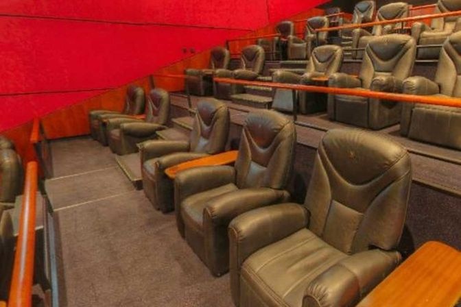 Rows of Gold Class seats inside a Vue International cinema.