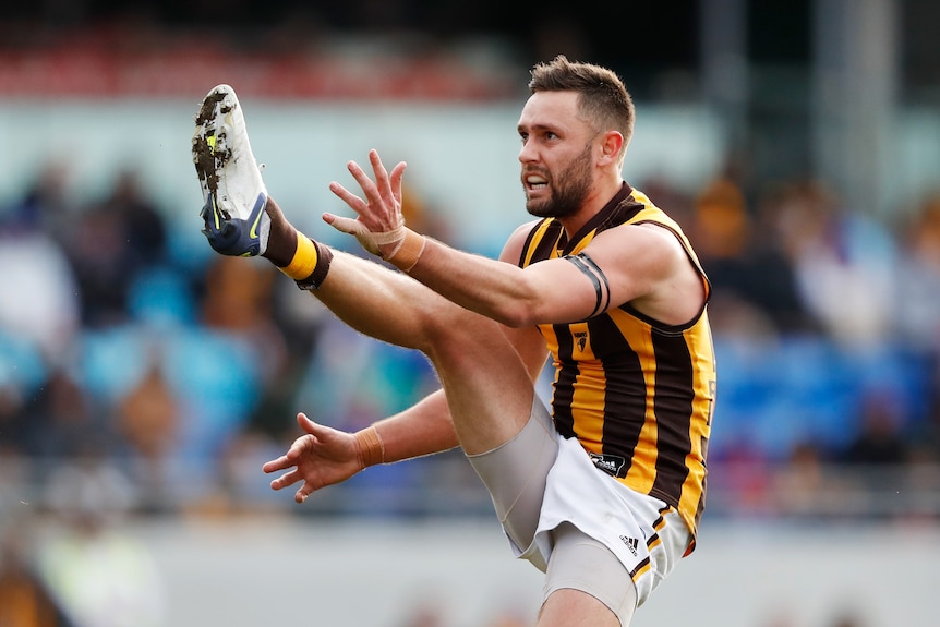 Jack Gunston's boot is hugh as he follows through after a shot on goal