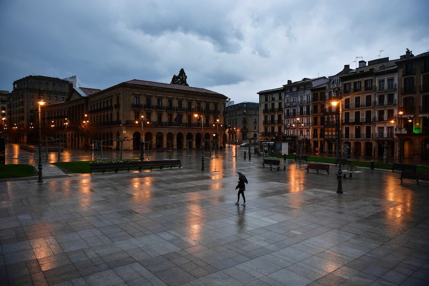A person walks through an empty Plaza del Castillo square in the old city, in Pamplona.