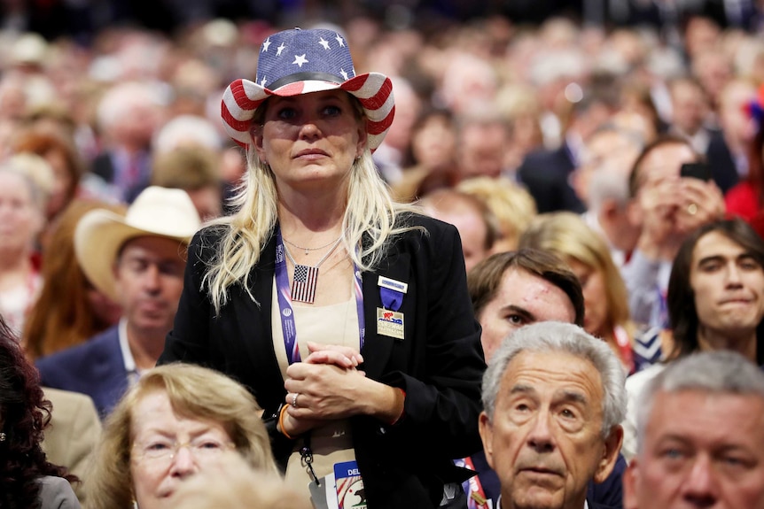 A Republican delegate wears an American flag hat.