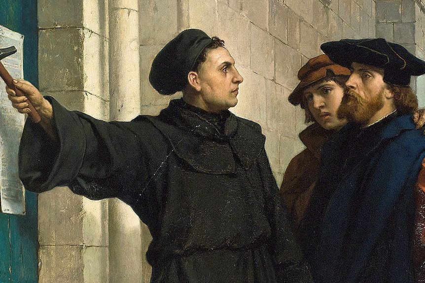 Painting of Martin Luther nailing his Ninety-five Theses to a church door.