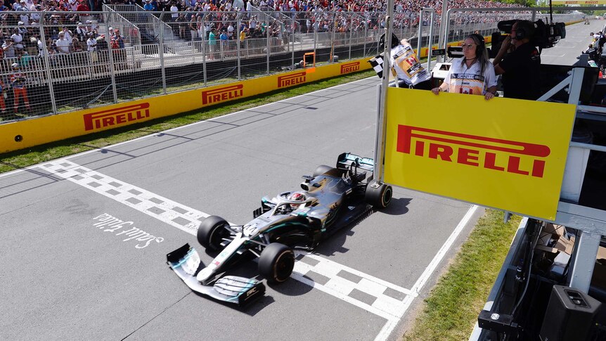 A Formula One driver crosses the finish line in Canada.