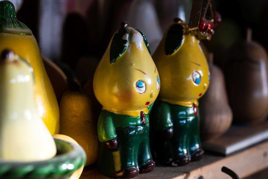 Two ceramic pears with faces