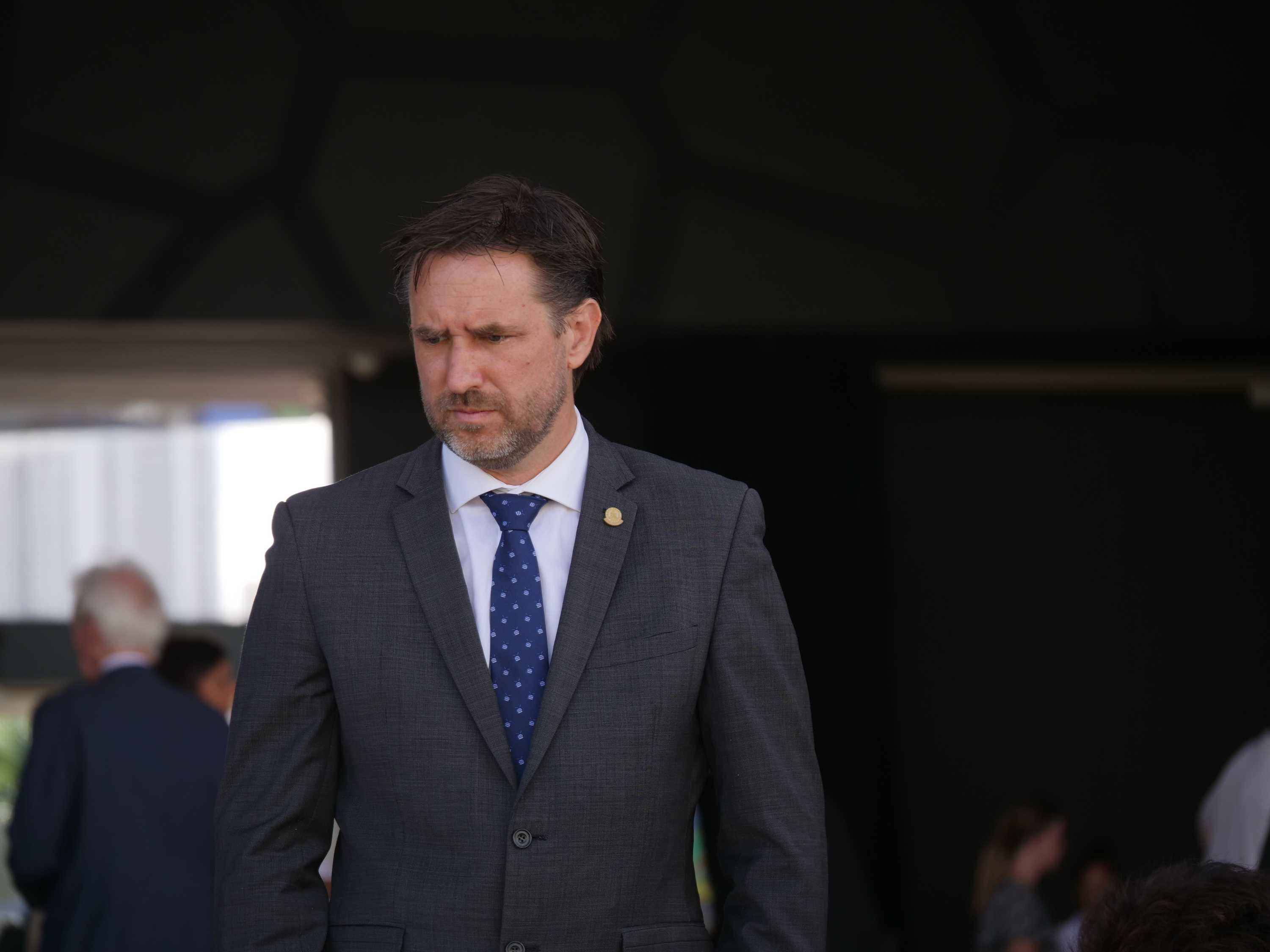 man in suit looking down.