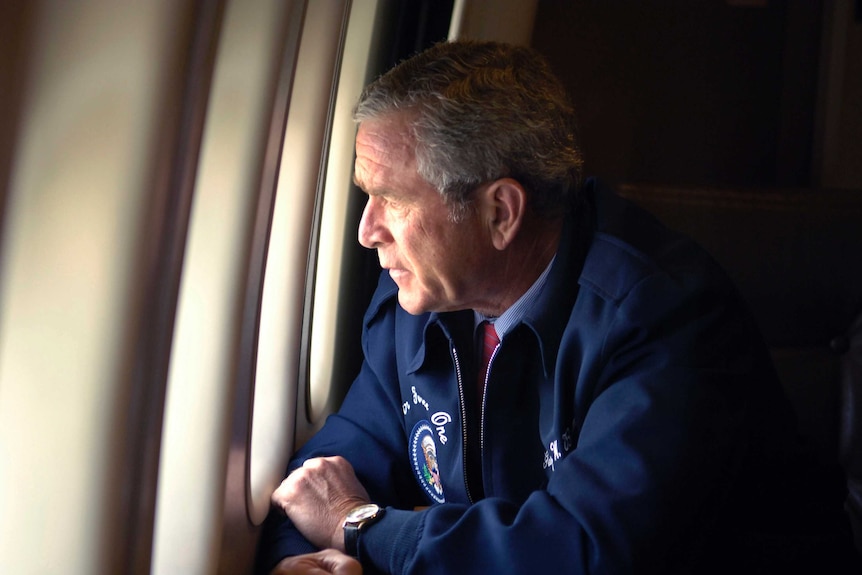 US President Bush peers out the window of Air Force One as he surveys the damage along the Gulf Coast states.