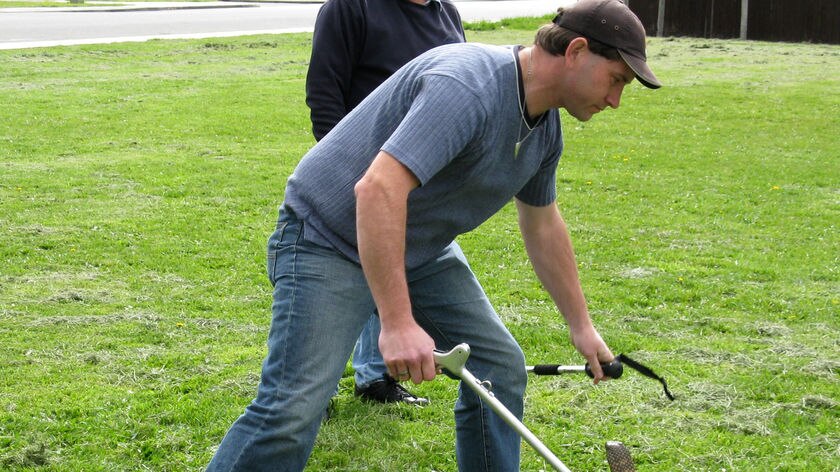 A man catches a snake at the training course.