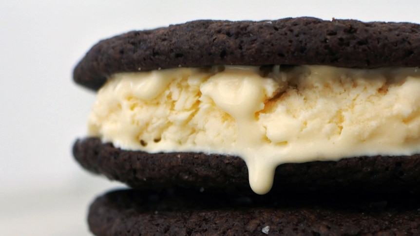 Three chocolate ice cream sandwiches stacked on top of each other, an easy dessert recipe.