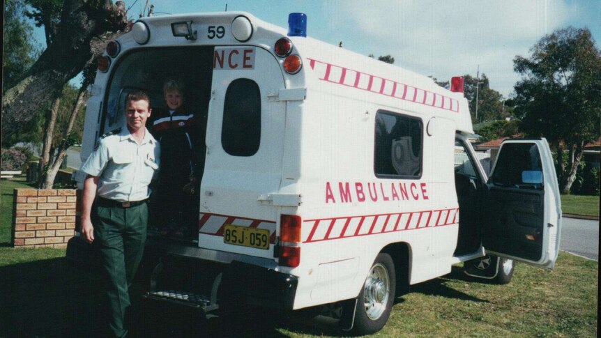 Bill Devine in front of an ambulance
