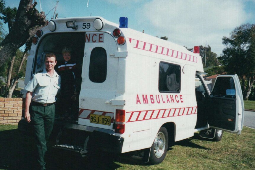 Bill Devine in front of an ambulance