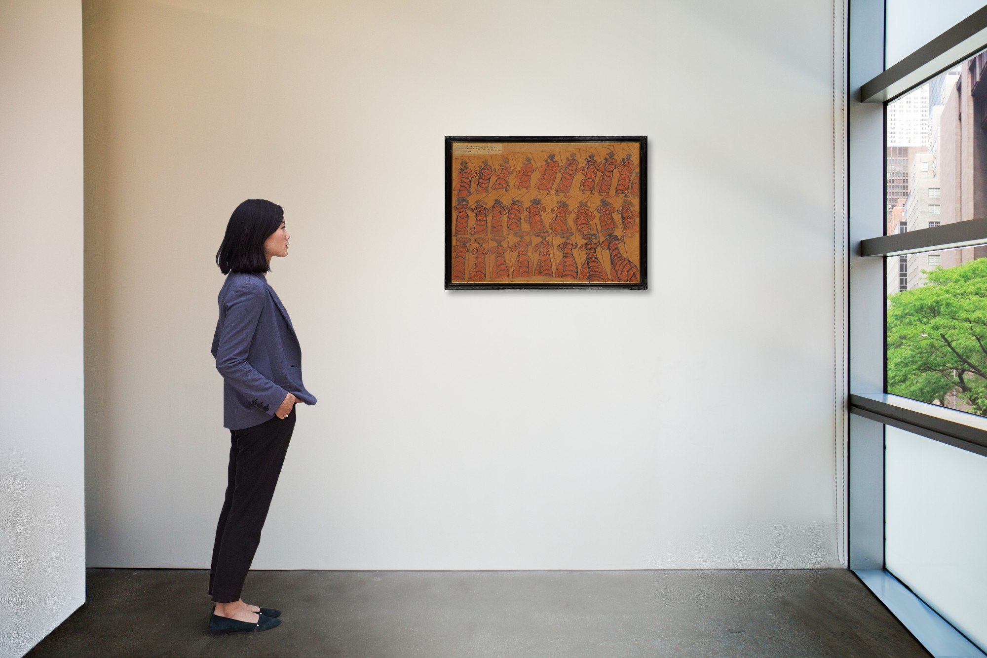 A woman stands in front of William Barak's Corroboree (Women in possum skin cloaks), 1897.