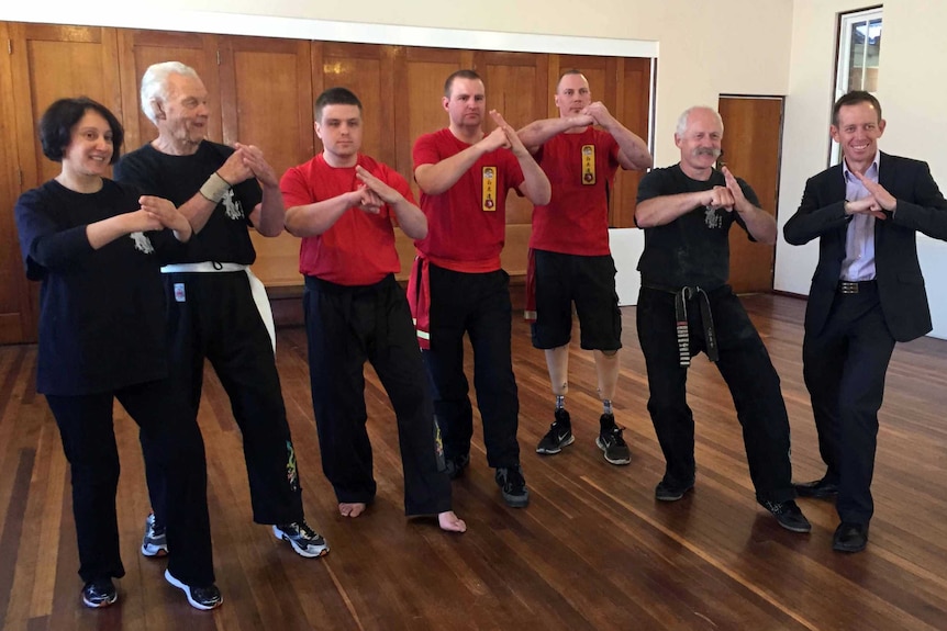 Kung Fu students pose with Grand Master Neal Hardy and Sports Minister Shane Rattenbury