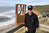 Mick Fanning poses with the bell trophy at Bells Beach.
