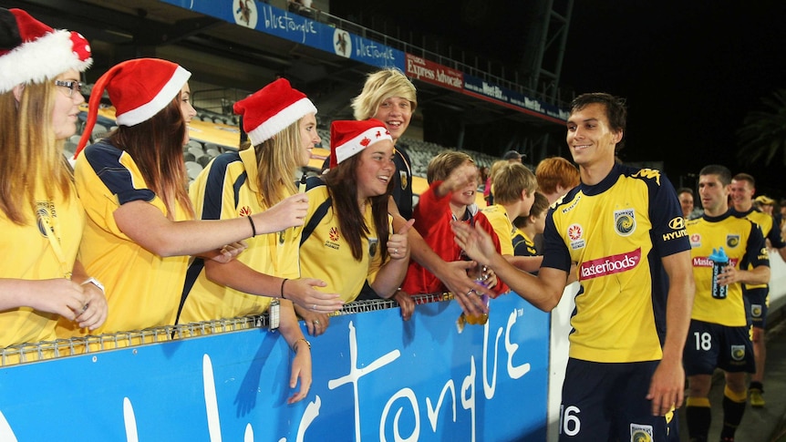 Trent Sainsbury celebrates with fans after Central Coast beat the Melbourne Heart in Gosford.