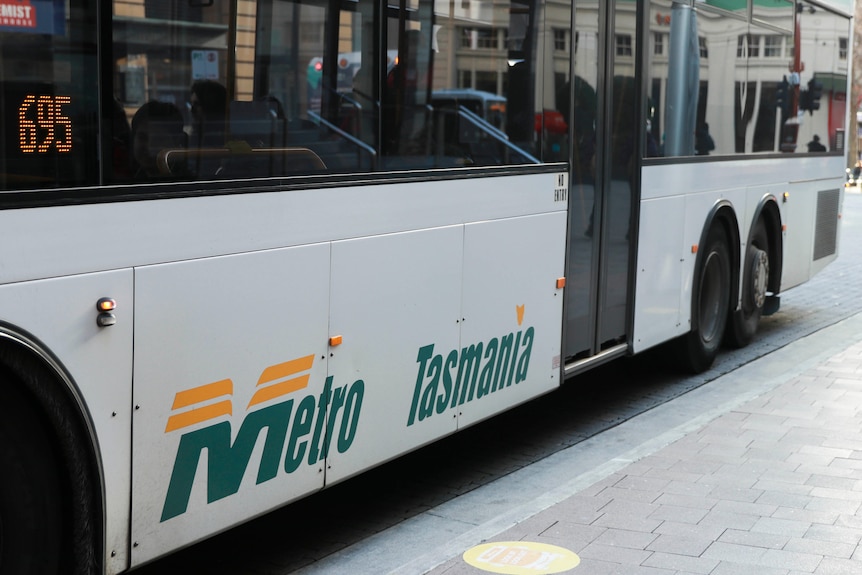 A bus with the words Metro Tasmania painted onto the side.