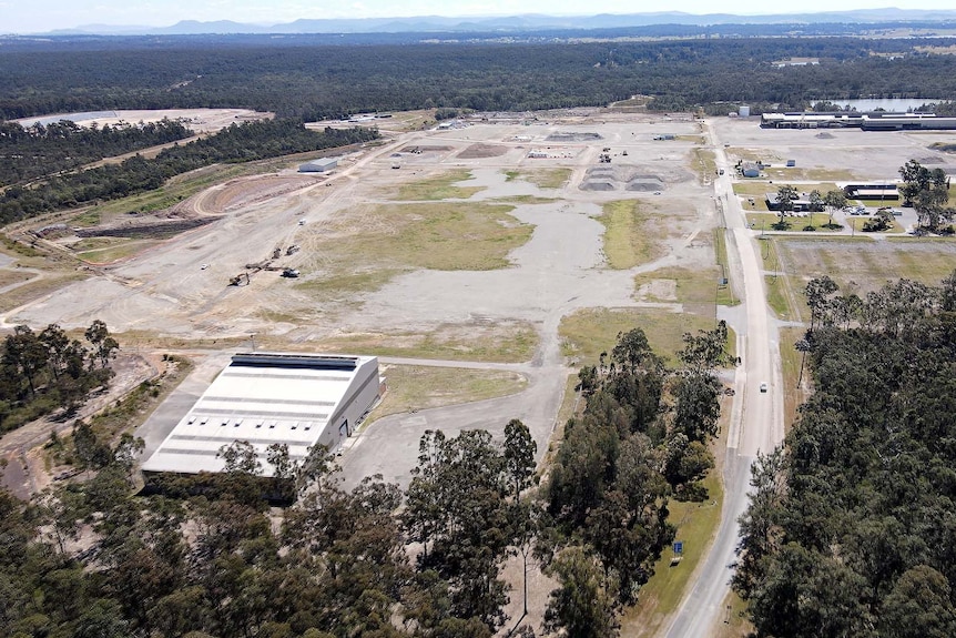 aerial shot of a plot of empty land where a power plant will be built